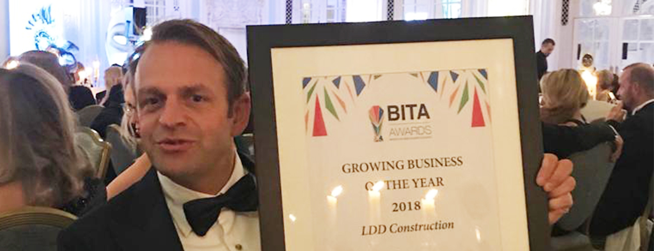 Tuxedoed owner of LDD Construction, Ziggy Seagroatt holding his award for 'Growing Business of the Year 2018' at Bita Awards.